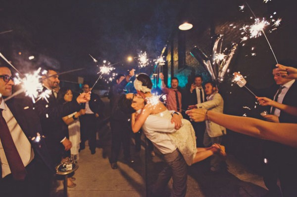 green building wedding reception with sparklers