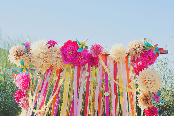 colorful pompom and streamer ceremony backdrop